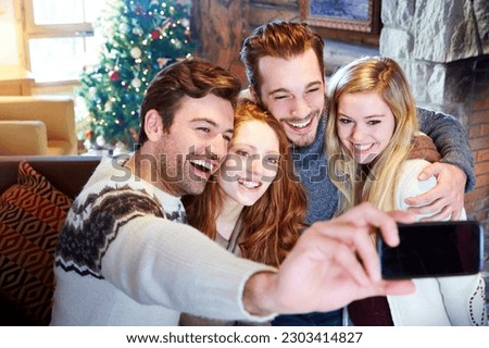 Friends taking picture together in log cabin