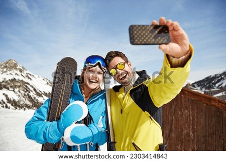 Couple taking picture together in the snow