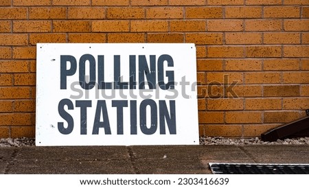 A polling station sign on election day Royalty-Free Stock Photo #2303416639