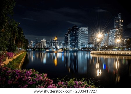 Night view at the side of the lake, beside the Queen Sirikit Convention Center, also known as Benjakitti Park, Bangkok, Thailand.