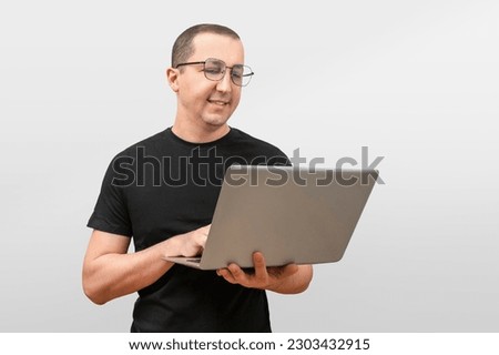Successful young man, freelance student working with laptop on white background.