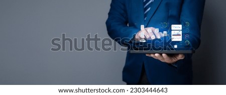 Businessman with hologram, data analysis technology, computer data analysis, the use of computer technology to help analyze business data, customers and prospects for efficiency and quality. Royalty-Free Stock Photo #2303444643