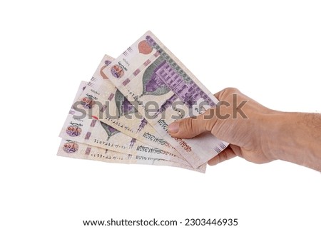 hands holding 200 Egyptian pound notes Royalty-Free Stock Photo #2303446935