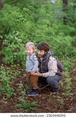 
Europeans father and son in the forest in early spring