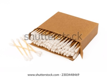 Cotton buds in eco kraft packaging isolated on white background. Cotton swab on a white background. Sticks for hygiene of the nose and ears. Bamboo cotton buds. Eco friendly. Royalty-Free Stock Photo #2303448469