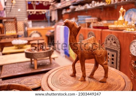 Wooden handmade statuette of Camels in souvenir shop Royalty-Free Stock Photo #2303449247
