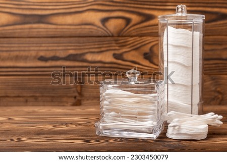 Cotton buds on a textured brown background. Cotton swab on a white background. Sticks for hygiene of the nose and ears. Space for text.Space for copy.