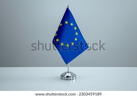EU flag in a stand on table Royalty-Free Stock Photo #2303459189