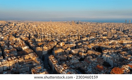 Aerial view of Barcelona city skyline, Gracia and Eixample residential urban grid at sunset, Catalonia, Spain