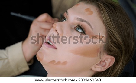 Facial contour is applied to the female model. It is a life style makeup photo.