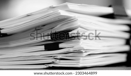 Pile of papers with binder clips paperclips business for organizing on Desk Work to Be done Royalty-Free Stock Photo #2303464899