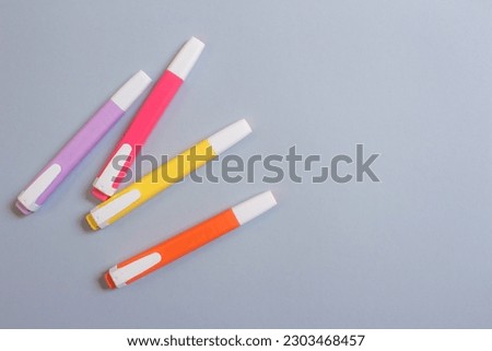 Colorful markers on a grey background. Top view of felt-tip pens with copy space.