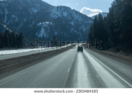 A highway in the mountains with a mountain in the background