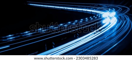 blue lines of car lights on black background Royalty-Free Stock Photo #2303485283