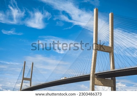 Alex Fraser Bridge on a sunny day North Delta Greater Vancouver Canada. Modern bridge pylon against blue sky. Multi-span cable-stayed bridge.Linear perspective view of a cable-stayed suspension Bridge Royalty-Free Stock Photo #2303486373
