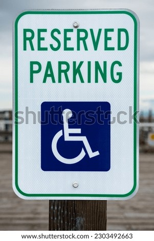 Handicapped parking spot. Blue handicapped sign parking spot. Disabled parking permit sign on pole. Reserved parking lot for mobility or disable people