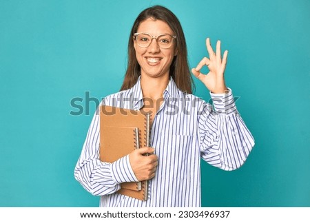 A young caucasian secretary woman isolated cheerful and confident showing ok gesture.