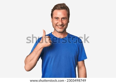 A middle-aged man isolated smiling and raising thumb up