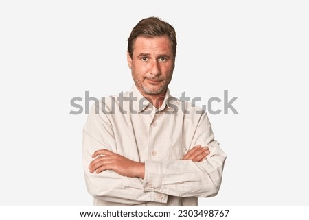 A middle-aged man isolated suspicious, uncertain, examining you. Royalty-Free Stock Photo #2303498767