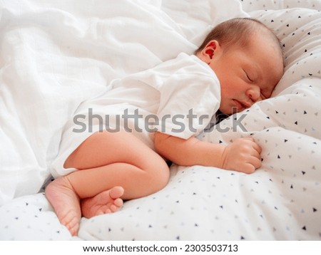 A baby boy sleeping on the bed, infant sleeps Royalty-Free Stock Photo #2303503713