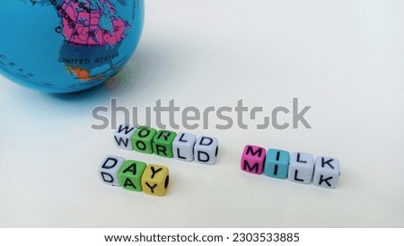world milk day written on white background with mini globe