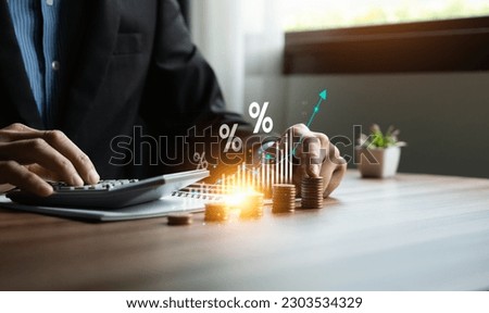 Interest rate and dividend concept, Businessman is calculating income and return on investment in percentage. income, return, retirement, compensation fund, investment, dividend tax, stock market Royalty-Free Stock Photo #2303534329