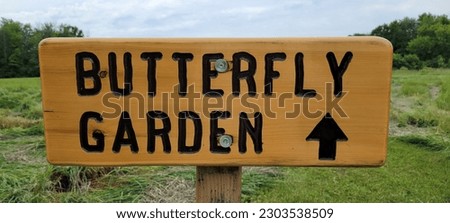 Wooden Butterfly Garden Sign, Park in Background