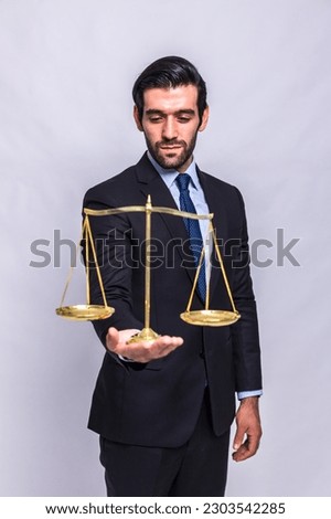 Lawyer showing small golden justice scale. Business Man hold Weight scale of justice, lawyer or attorney concept
