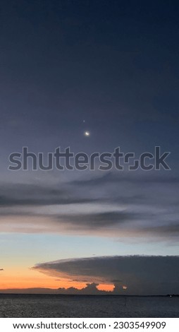 View of the moon and venus from the coast