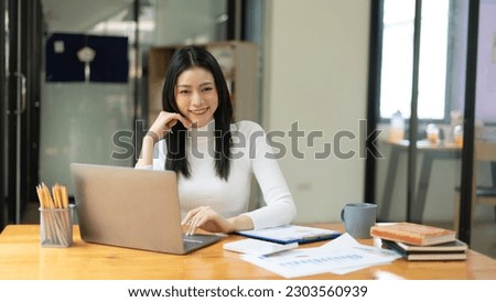 Portrait Of Smiling Beautiful Businesswoman Using Laptop Against White Background.