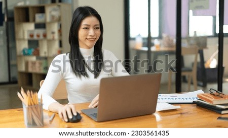 Remote business concept, Businesswoman use laptop to reading data and typing marketing plan report.