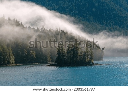 Morning mist along Inside Passage cruise between Prince Rupert and Port Hardy, British Columbia, Canada. Royalty-Free Stock Photo #2303561797