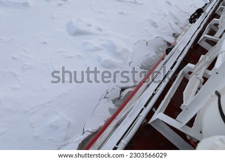 An icebreaker is a special-purpose ship or boat designed to move and navigate through ice-covered waters, and provide safe waterways for other boats and ships. Royalty-Free Stock Photo #2303566029
