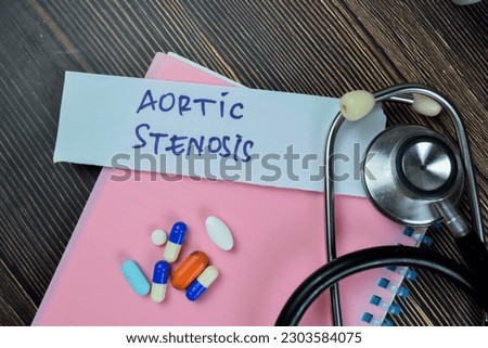 Concept of Aortic Stenosis write on sticky notes with stethoscope isolated on Wooden Table.
