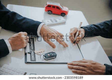 The young businessman made a lease for a new car in the office of a car dealer and received the keys after the contract was completed. The concept of a car purchase contract