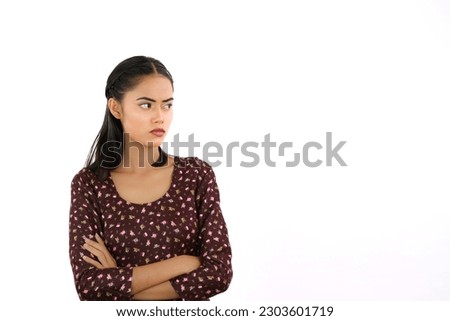 Angry Young Indian Girl Looking Sideways with Arms Crossed - Face Expressions Royalty-Free Stock Photo #2303601719