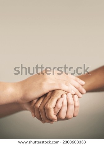 Help, support and love with people holding hands in comfort, care or to console each other. Trust, empathy or healing with friends praying together during depression, anxiety or the pain of loss Royalty-Free Stock Photo #2303603333