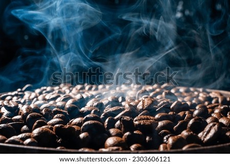 Coffee beans roasting with smoke,  selective focus, and soft focus. Royalty-Free Stock Photo #2303606121