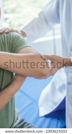 Professional massage therapist physiotherapy worker rehabilitation physiotherapy man at work with patient man client at clinic Royalty-Free Stock Photo #2303621033