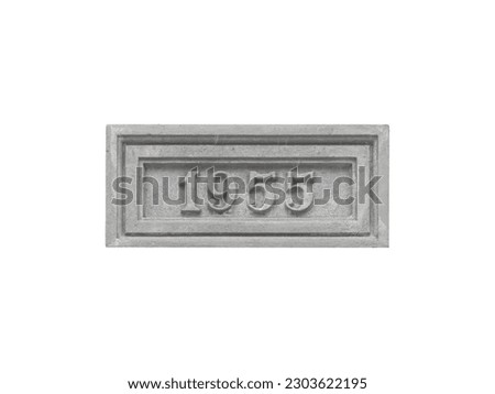Concrete monumental sign with the inscription 1955 isolated on a white background.
