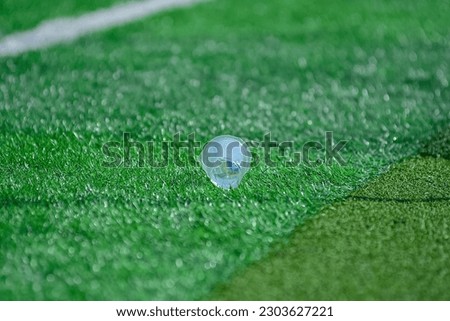 plastic cup on football grass 