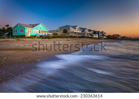 Waves in the Atlantic Ocean and beachfront homes at sunrise, Edisto Beach, South Carolina. Royalty-Free Stock Photo #230363614