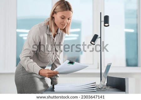 Businesswoman working with documents in modern office. Space for text