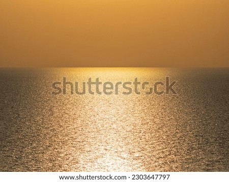 Golden background, Seascape, summer warm sea. Sunset, evening, golden glare. Photo.