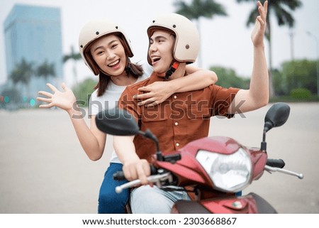 Young Asian couple on the motorbike Royalty-Free Stock Photo #2303668867