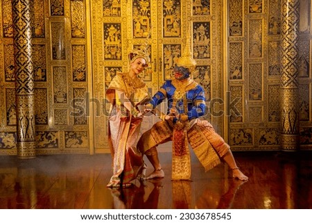 Beautiful Asian woman wear Thai traditional dress action of dancing together with Thai classic masked from the Ramakien character as blue monkey.