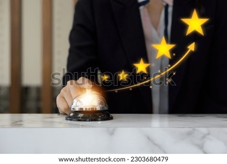 Businesswoman hand ringing silver service bell on hotel reception desk, shows the sign of the top service Quality assurance 5 star, Guarantee, Standards, ISO certification and standardization concept