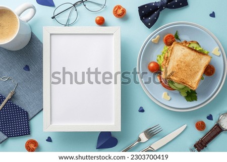 Surprise Dad with a special breakfast on Father's Day. Top view of a homemade sandwich, coffee cup, napkin, necktie, and other men's accessories on pastel blue background with an empty frame for text