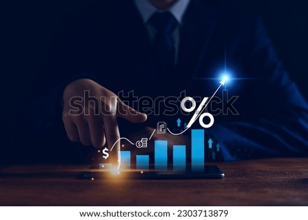 Interest rate and dividend concept. Businessman with percentage symbol and up arrow, Interest rates continue to increase, return on stocks and mutual funds, long term investment for retirement. Royalty-Free Stock Photo #2303713879