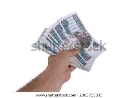 hand holding Egyptian money isolated on white background Royalty-Free Stock Photo #2303715035